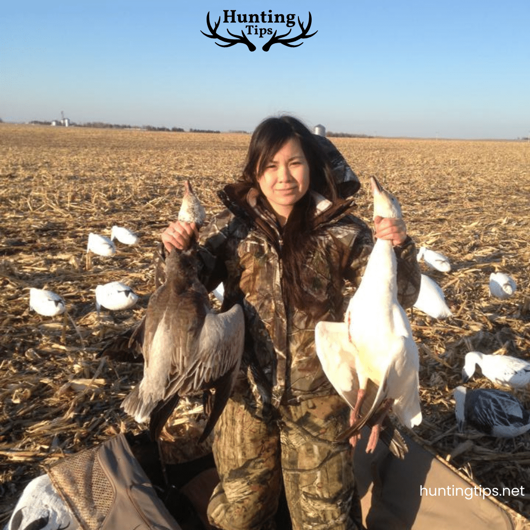 a female hunter holding the snow goose