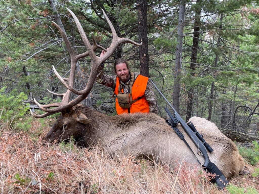 a man with the hunted elk and his weapon