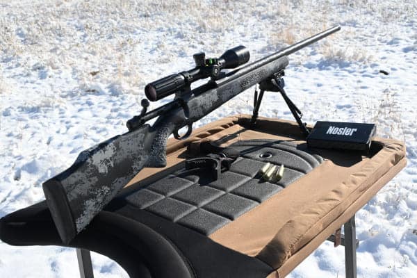 gun set up in a snowy area for wolf hunting