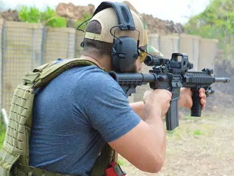 a man wearing the hearing protection while focusing on the target to shoot