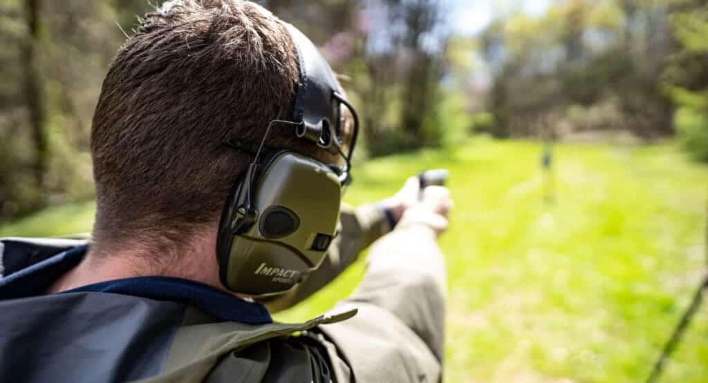 a man wearing the hearing protection while shooting