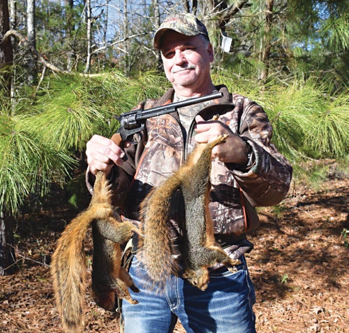 a hunter holding squirrels in his hands