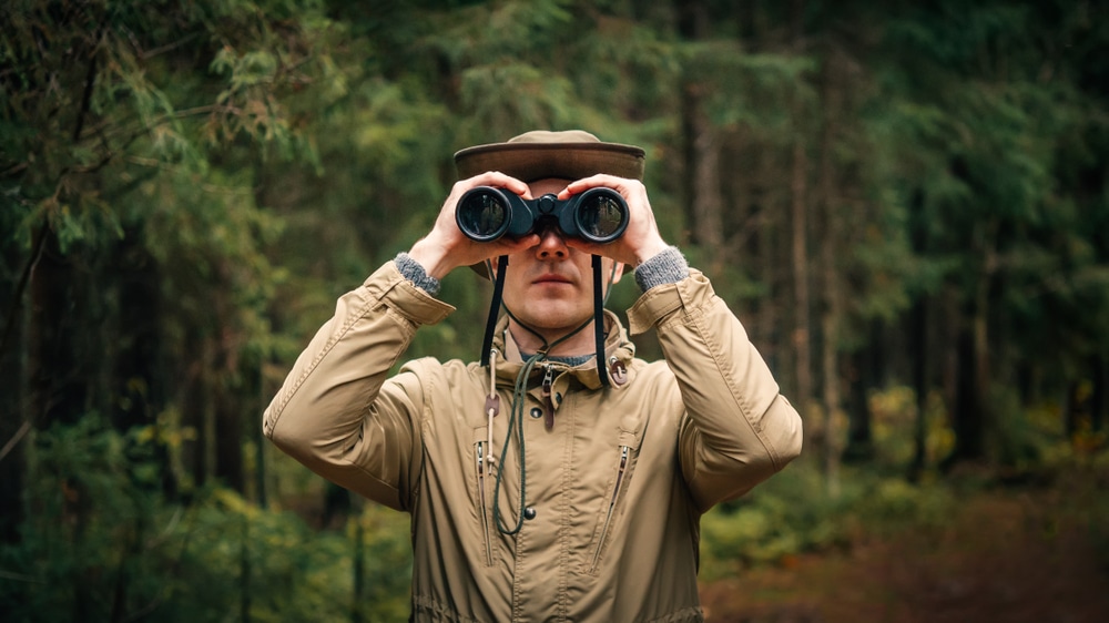 a hunter with the hunting binoculars