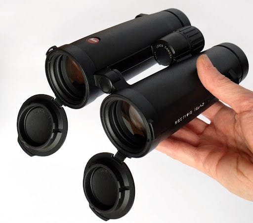 a person holdig a Leica Noctivid x hunting optics