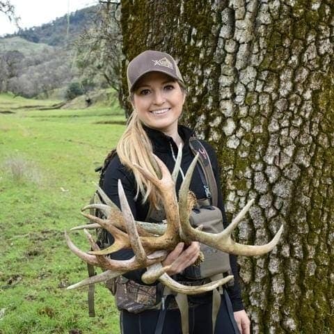 a women hunter holding the sheded horns