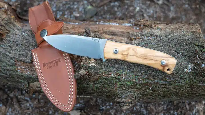 a wooden handle hunting knife with the leather cover