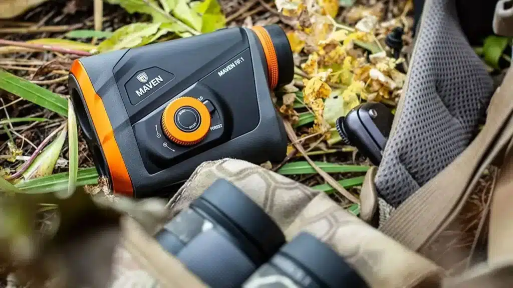 hunting rangefinder on a ground along with the hunting bag