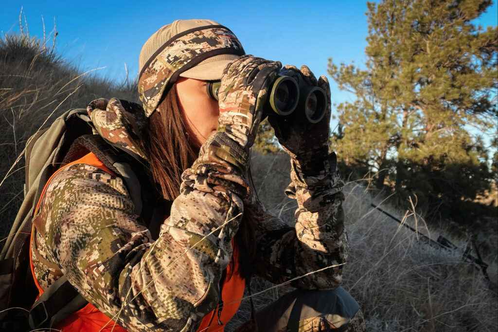 the female hunter using the binoculars