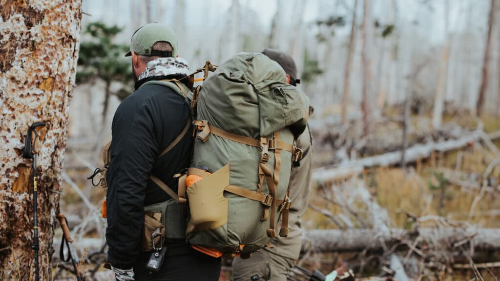 a hunter carrying Mystery Ranch Metcalf backpack