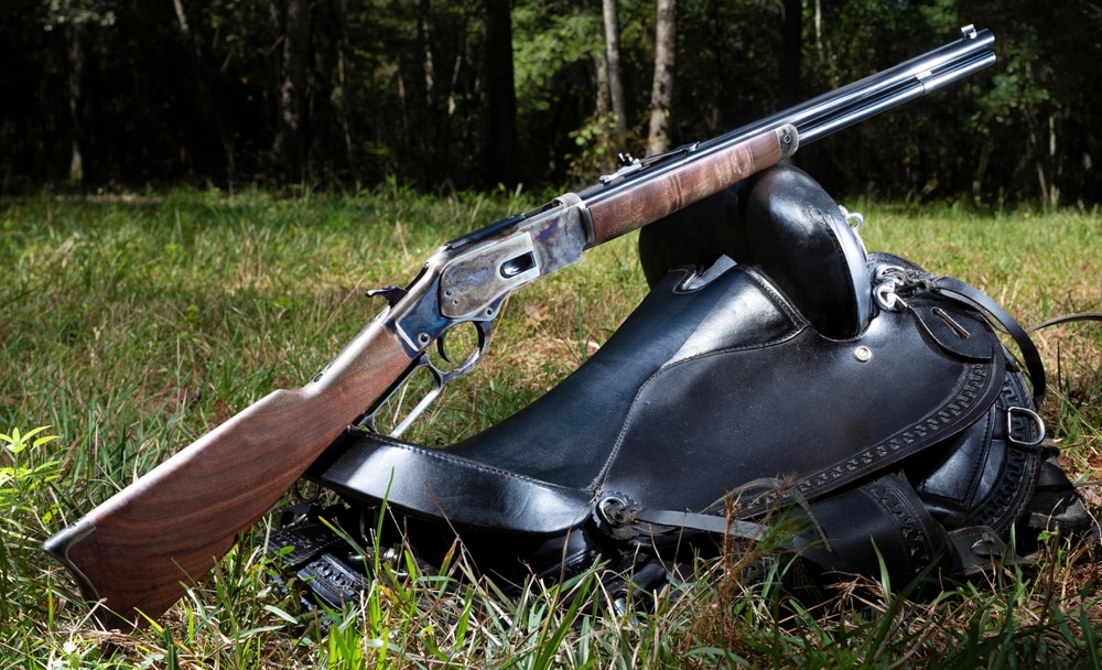 Cowboy Style Lever Action Rifle Resting On A Saddle In