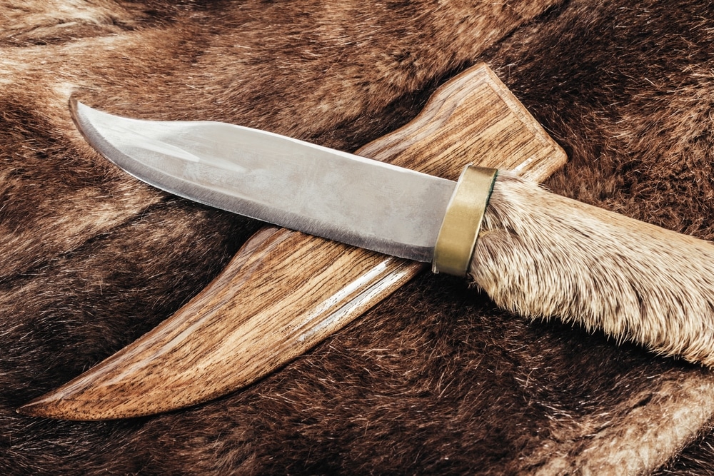 Photo Of Brown Colored Animal Fur Material With Hunting Knife