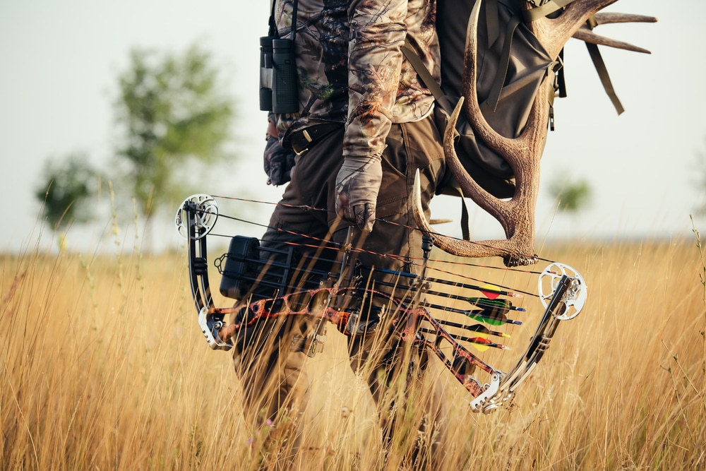 Close Up Shot Of A Hunter Dressed In Camouflage Clothing